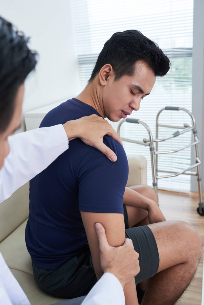 doctor palpating patients shoulder at clinic 2023 11 27 05 05 46 utc